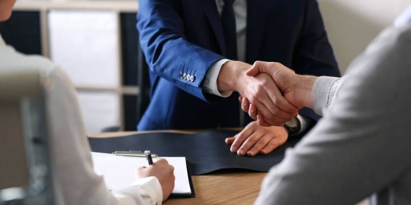 A tax advisor shaking hands with client.